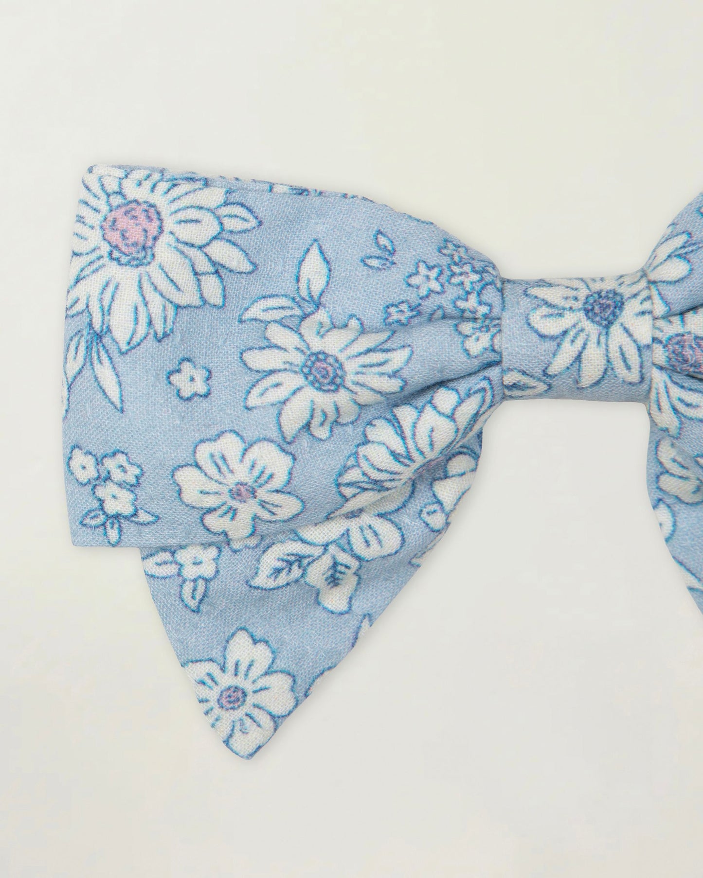 Early Sunday, Chiara Clip in Tonal Floral Blue color, made from Printed Cotton Tiny Swiss Dobby fabric, featuring a bow design on an alligator clip with a secure fit, shown in a closeup flat-lay view