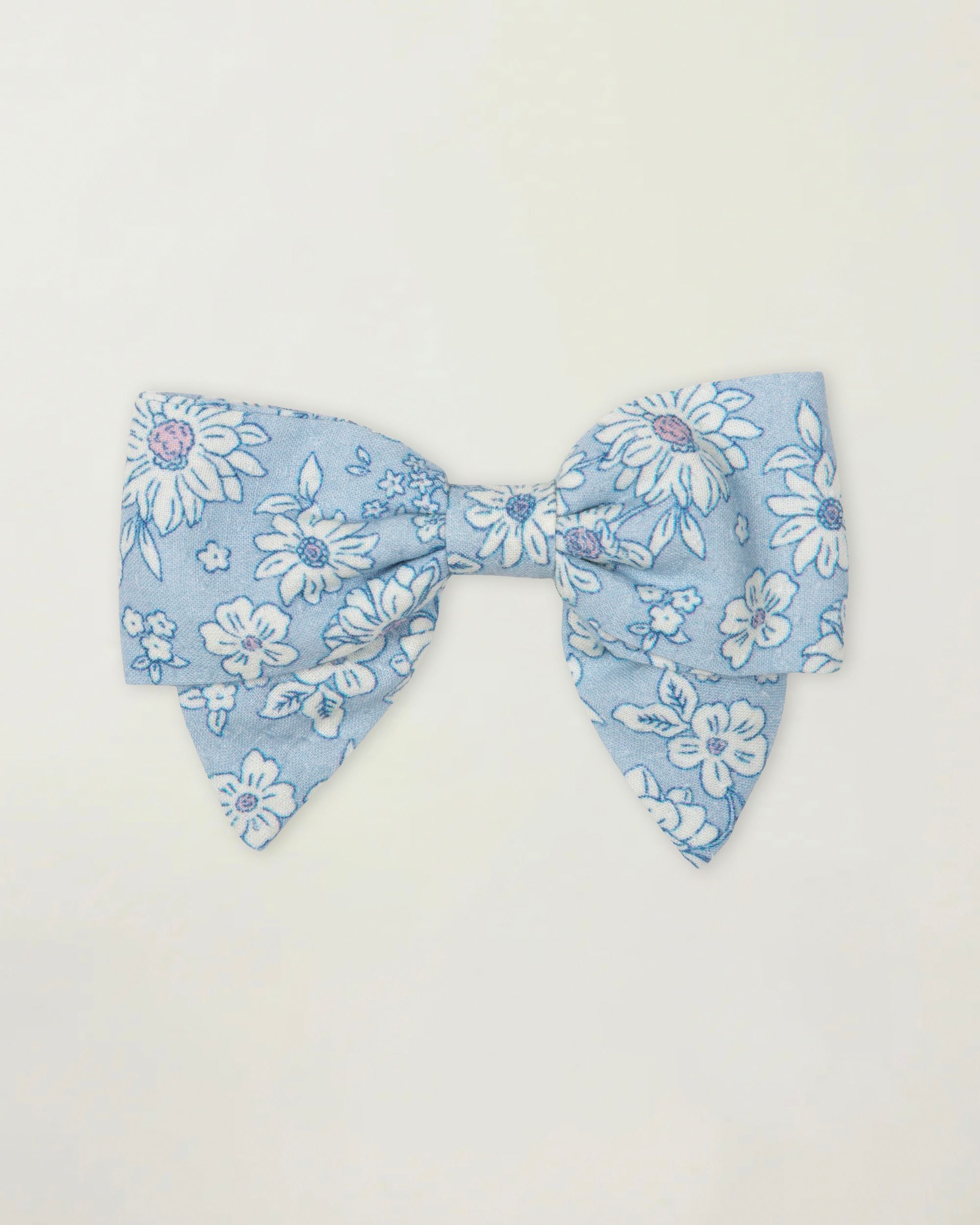 Early Sunday, Chiara Clip in Tonal Floral Blue color, made from Printed Cotton Tiny Swiss Dobby fabric, featuring a bow design on an alligator clip with a secure fit, shown in a front flat-lay view