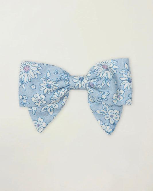 Early Sunday, Chiara Clip in Tonal Floral Blue color, made from Printed Cotton Tiny Swiss Dobby fabric, featuring a bow design on an alligator clip with a secure fit, shown in a front flat-lay view
