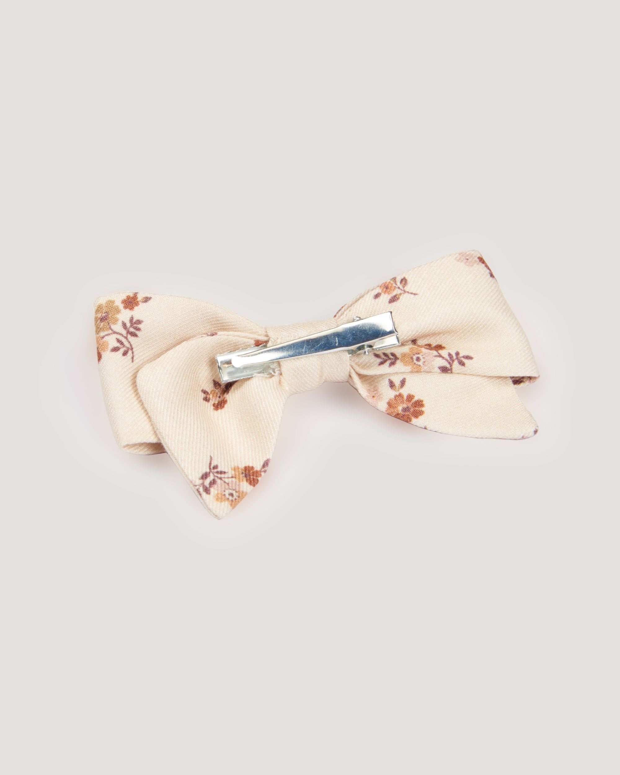 Early Sunday, Chiara Clip in Ditsy Bouquet Cream print, made from Printed Viscose Twill fabric, featuring a bow design on an alligator clip with a secure fit, shown in a back flat-lay view