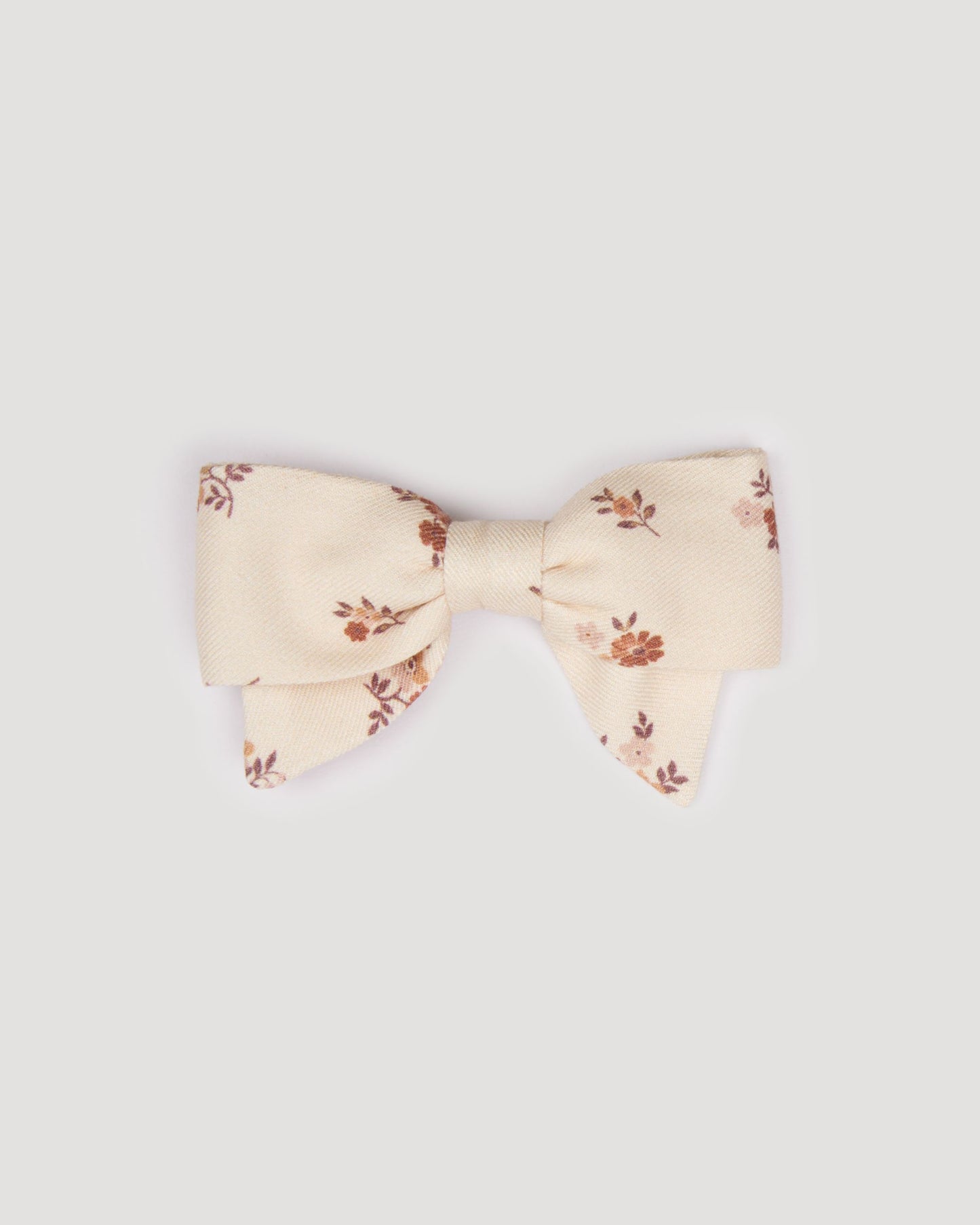 Early Sunday, Chiara Clip in Ditsy Bouquet Cream print, made from Printed Viscose Twill fabric, featuring a bow design on an alligator clip with a secure fit, shown in a front flat-lay view