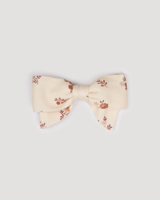 Early Sunday, Chiara Clip in Ditsy Bouquet Cream print, made from Printed Viscose Twill fabric, featuring a bow design on an alligator clip with a secure fit, shown in a front flat-lay view