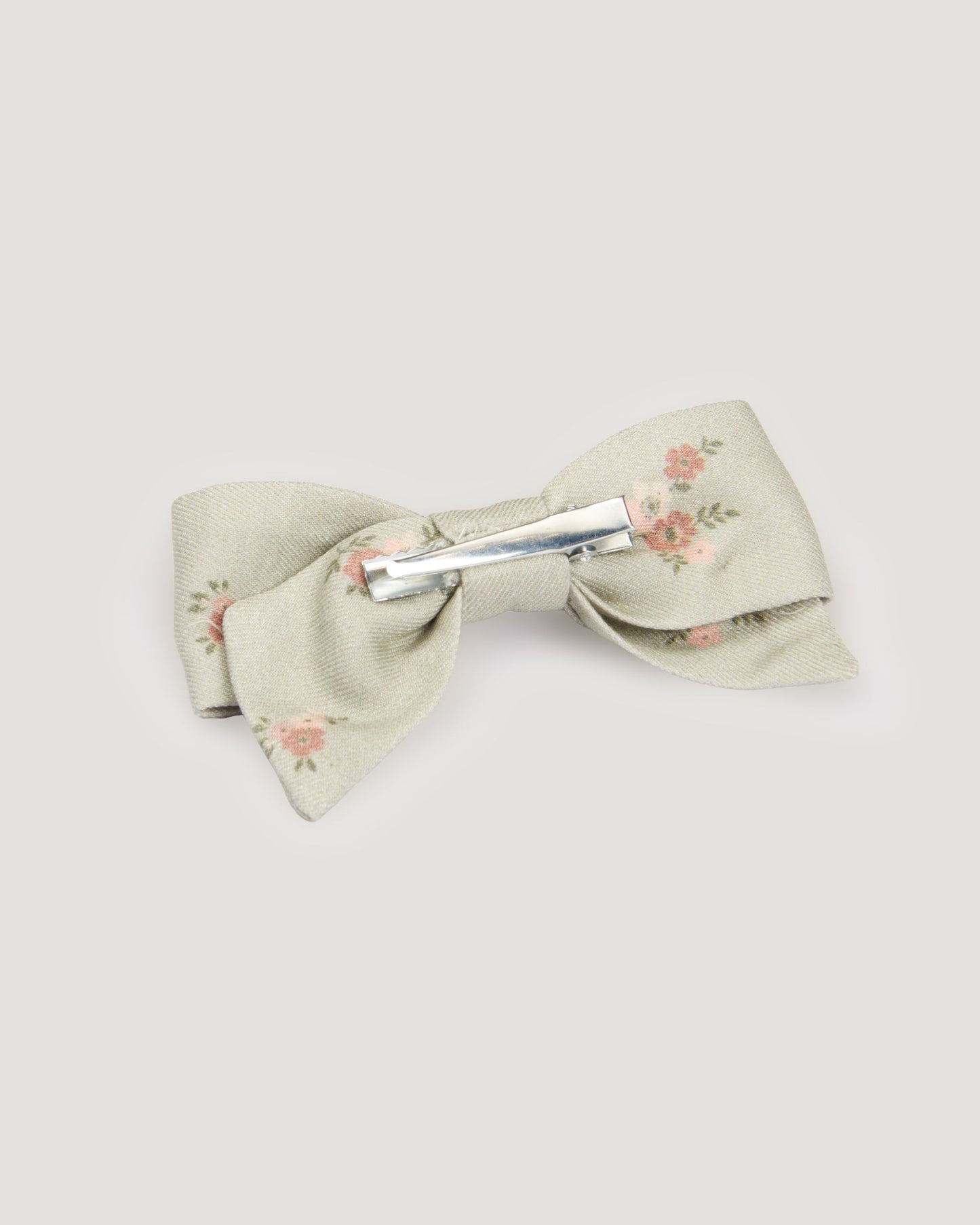 Early Sunday, Chiara Clip in Ditsy Bouquet Jade print, made from Printed Viscose Twill fabric, featuring a bow design on an alligator clip with a secure fit, shown in a back flat-lay view