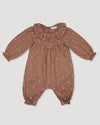 Early Sunday, Coco Baby Romper in Bark color, made from All-over Embroidered 30s Cotton Brushed Twill fabric, featuring ruffled neckline with leaf prints, shown in a front flat-lay view