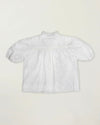 Early Sunday, Coco Blouse in Ivory color, made from all over embroidery fabric, featuring Puff sleeves, ruffled neckline and placket, shown in a back flat-lay view