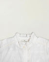 Early Sunday, Coco Blouse in Ivory color, made from all over embroidery fabric, featuring Puff sleeves, ruffled neckline and placket, shown in a closeup flat-lay view