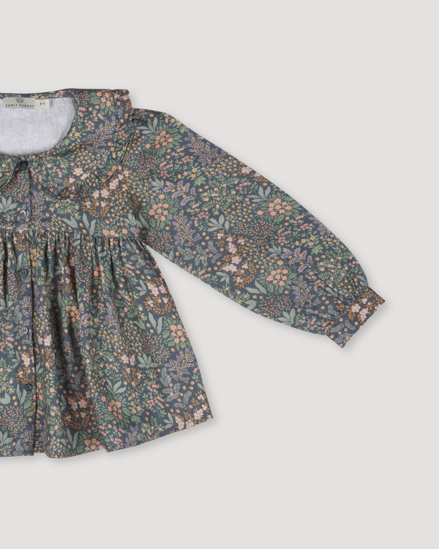 Early Sunday, Colette Blouse in Autumn Garden Greyish Blue, made from Printed Cotton Satin fabric, featuring relaxed fit, classic collar, and button-down front, shown in a closeup flat-lay view