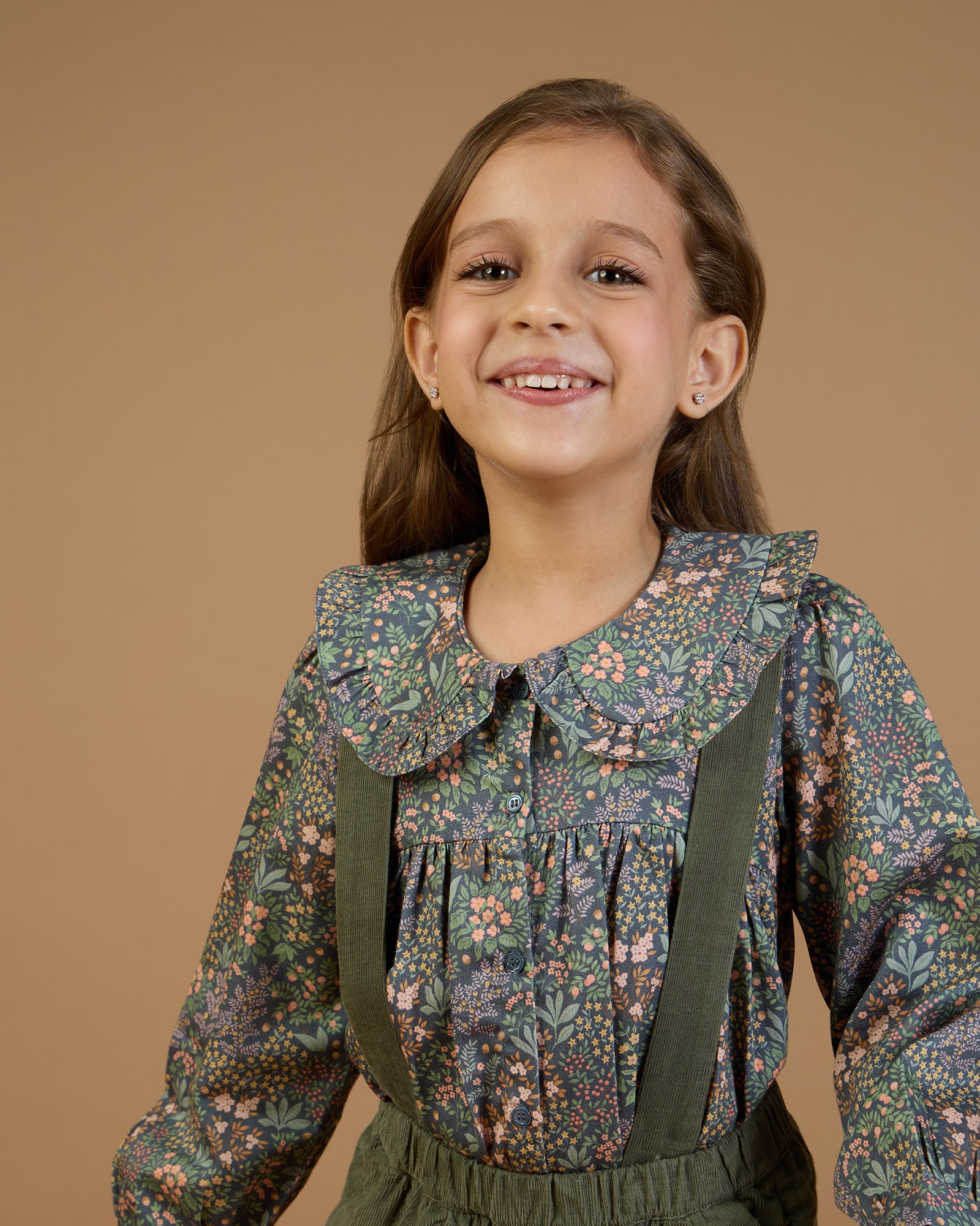 Early Sunday, Colette Blouse in Autumn Garden Greyish Blue, made from Printed Cotton Satin fabric, featuring relaxed fit, classic collar, and button-down front, shown in a close-up side view of a model wearing it