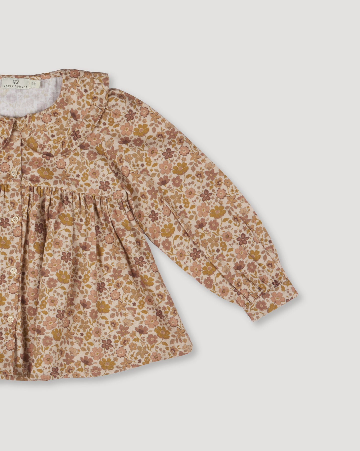 Early Sunday, Colette Blouse in Garden Flowers Dusty Pink, made from Printed Cotton Satin fabric, featuring relaxed fit, classic collar, and button-down front, shown in a closeup flat-lay view