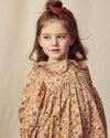Early Sunday, Colette Blouse in Garden Flowers Dusty Pink, made from Printed Cotton Satin fabric, featuring relaxed fit, classic collar, and button-down front, shown in a close-up side view of a model wearing it