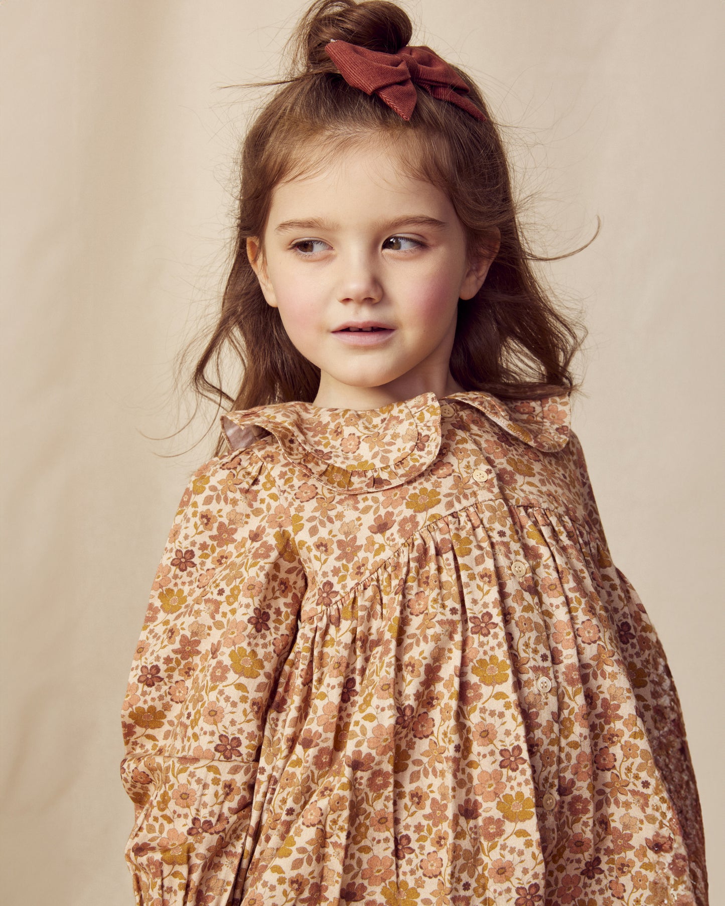 Early Sunday, Colette Blouse in Garden Flowers Dusty Pink, made from Printed Cotton Satin fabric, featuring relaxed fit, classic collar, and button-down front, shown in a close-up side view of a model wearing it