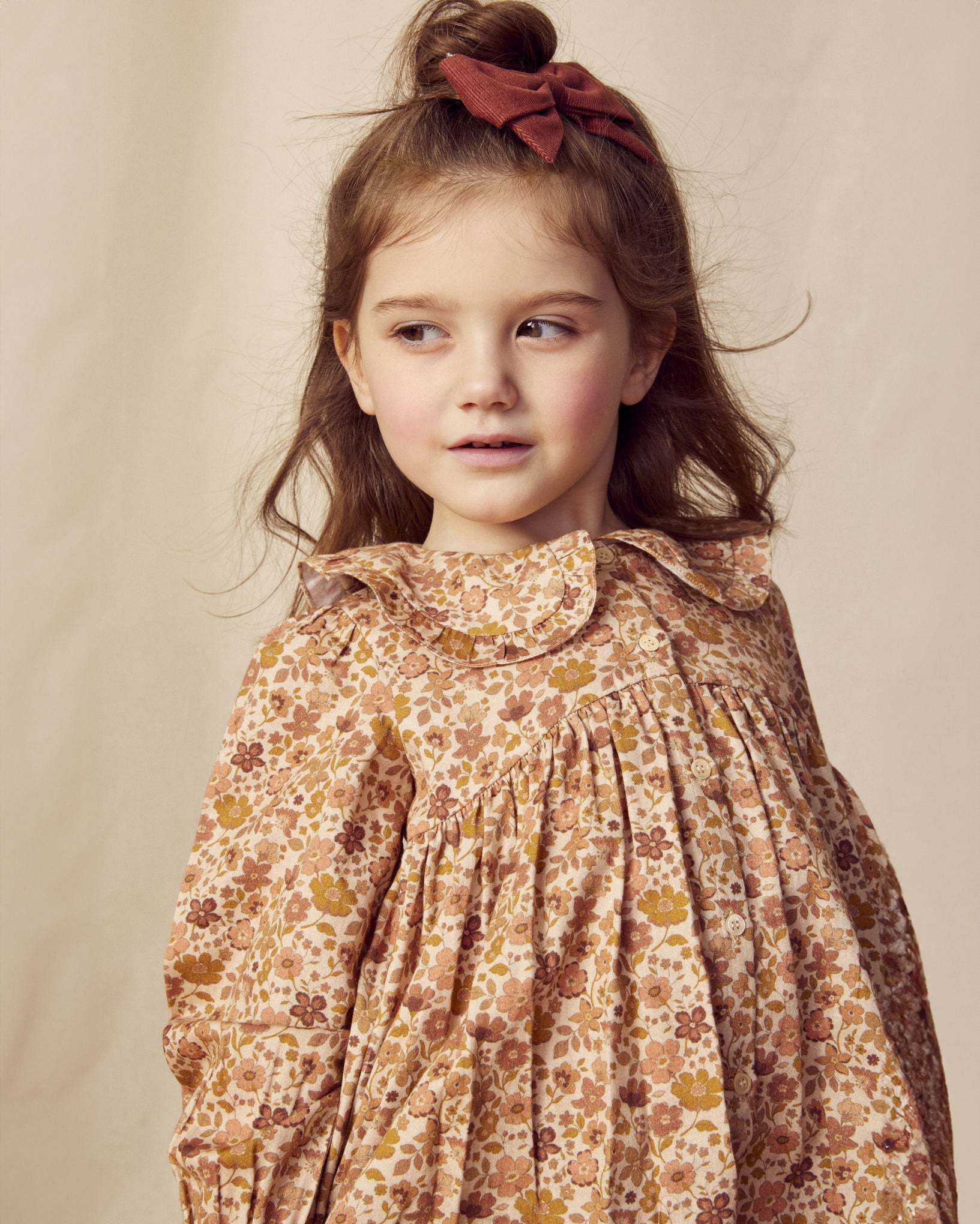 Early Sunday, Colette Blouse in Garden Flowers Dusty Pink, made from Printed Cotton Satin fabric, featuring relaxed fit, classic collar, and button-down front, shown in a close-up side view of a model wearing it