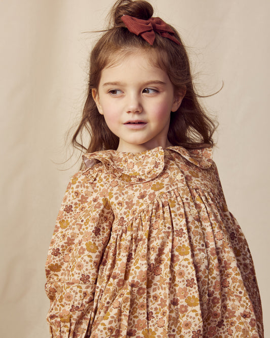Early Sunday, Colette Blouse in Garden Flowers Dusty Pink, made from Printed Cotton Satin fabric, featuring relaxed fit, classic collar, and button-down front, shown in a close-up side view of a model wearing it
