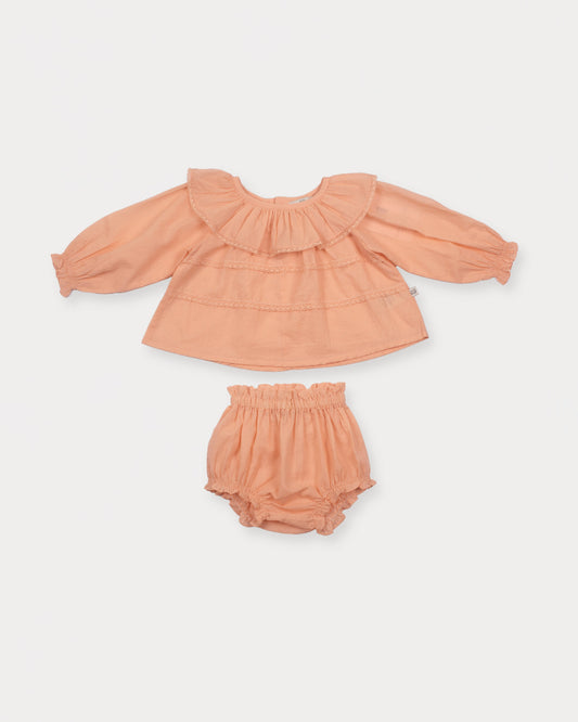 Early Sunday, Daisy Baby Blouse & Bloomer Set in Dusty Pink, made from Cotton Dobby Spot fabric, featuring a frilly neckline & detailed lace yoke with matching bloomer, shown in a front flat-lay view