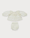 Early Sunday, Daisy Baby Blouse & Bloomer Set in Ivory, made from Cotton Dobby Spot fabric, featuring a frilly neckline & detailed lace yoke with matching bloomer, shown in a front flat-lay view