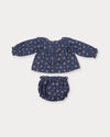 Early Sunday, Daisy Baby Blouse & Bloomer Set in Ditsy Bouquet Navy, made from Printed Cotton Satin fabric, featuring a frilly neckline with detailed lace yoke & gathered sleeves, shown in a back flat-lay view