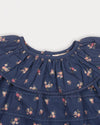 Early Sunday, Daisy Baby Blouse & Bloomer Set in Ditsy Bouquet Navy, made from Printed Cotton Satin fabric, featuring a frilly neckline with detailed lace yoke & gathered sleeves, shown in a closeup flat-lay view