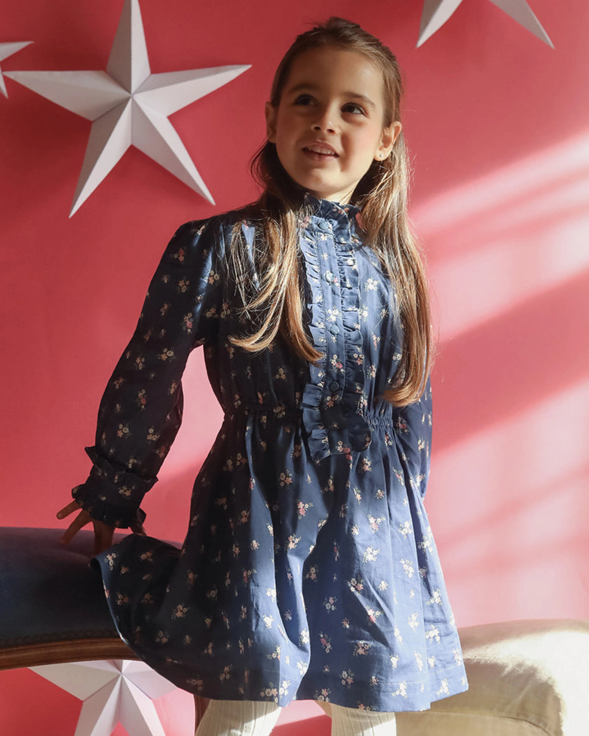 Early Sunday, Dawn Dress in Ditsy Bouquet Navy, made from Printed Cotton Satin fabric, featuring a soft flowing hem, shown in a front view of a model wearing it in a studio setting