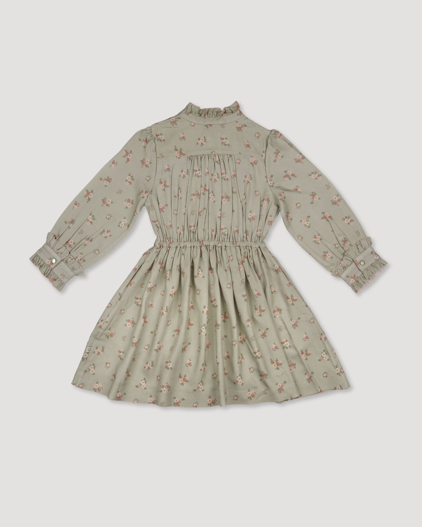 Early Sunday, Dawn Dress in Ditsy Bouquet Jade print, made from Printed Viscose Rayon Twill fabric, featuring Collar and sleeve cuffs trimmed with subtle ruffles for a nostalgic silhouette, shown in a back flat-lay view