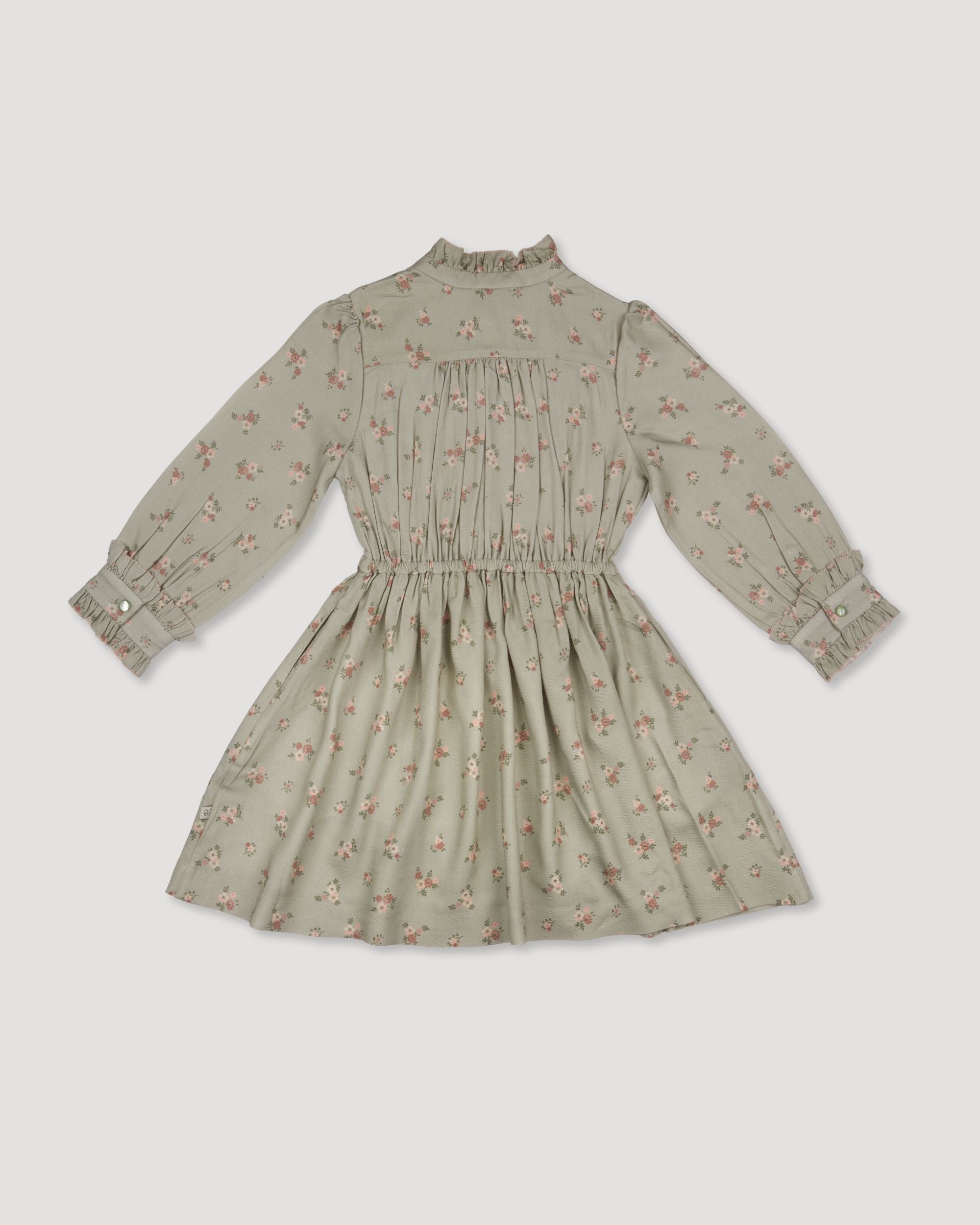 Early Sunday, Dawn Dress in Ditsy Bouquet Jade print, made from Printed Viscose Rayon Twill fabric, featuring Collar and sleeve cuffs trimmed with subtle ruffles for a nostalgic silhouette, shown in a back flat-lay view