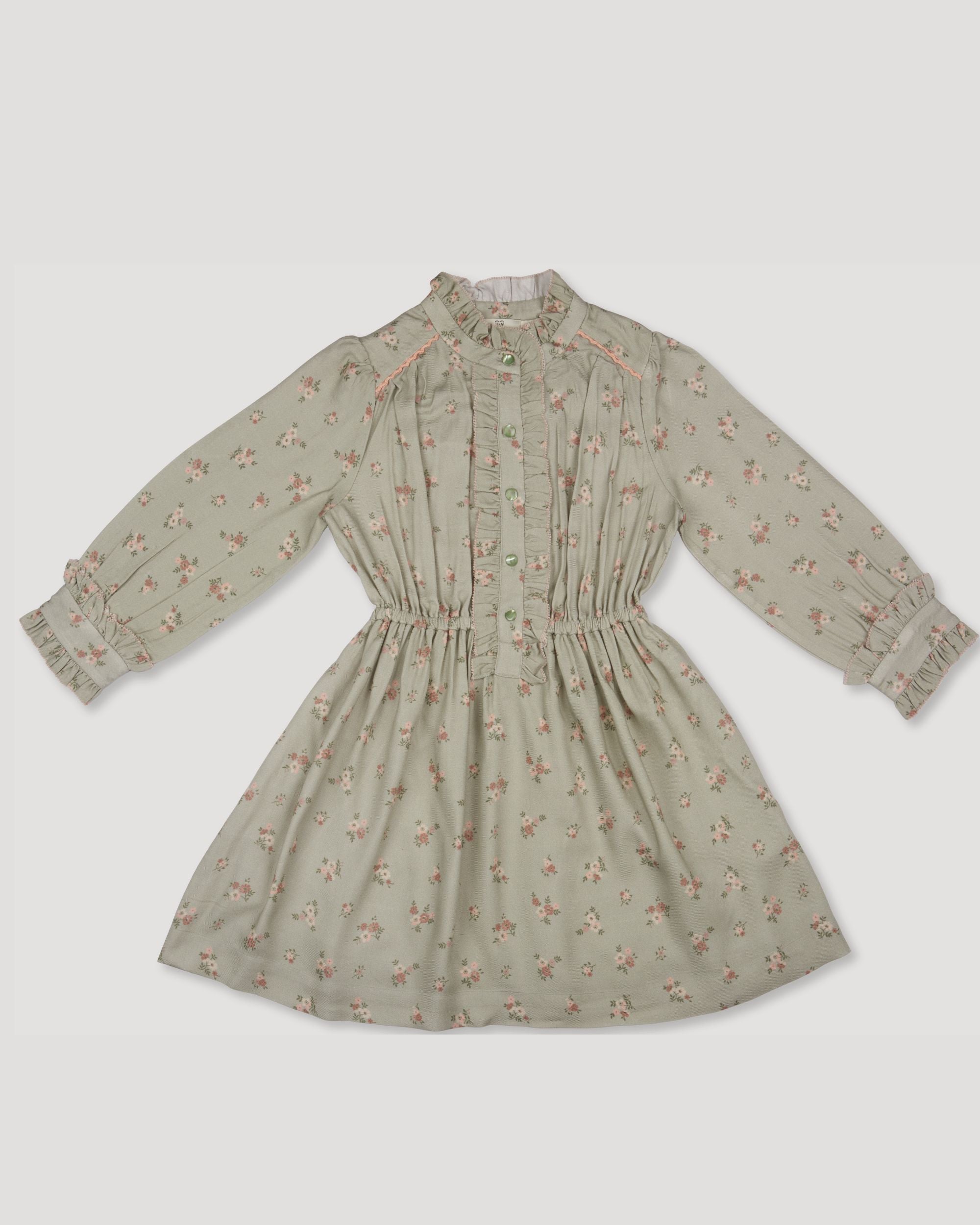 Early Sunday, Dawn Dress in Ditsy Bouquet Jade print, made from Printed Viscose Rayon Twill fabric, featuring Collar and sleeve cuffs trimmed with subtle ruffles for a nostalgic silhouette, shown in a front flat-lay view