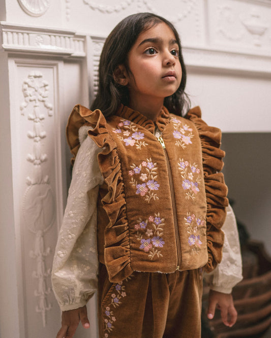 Early Sunday, Deborah Jacket in Almond, made from Dyed Cotton Velvet fabric, featuring Sleeveless design ideal for versatile layering in transitional weather, shown in a front view of model wearing it