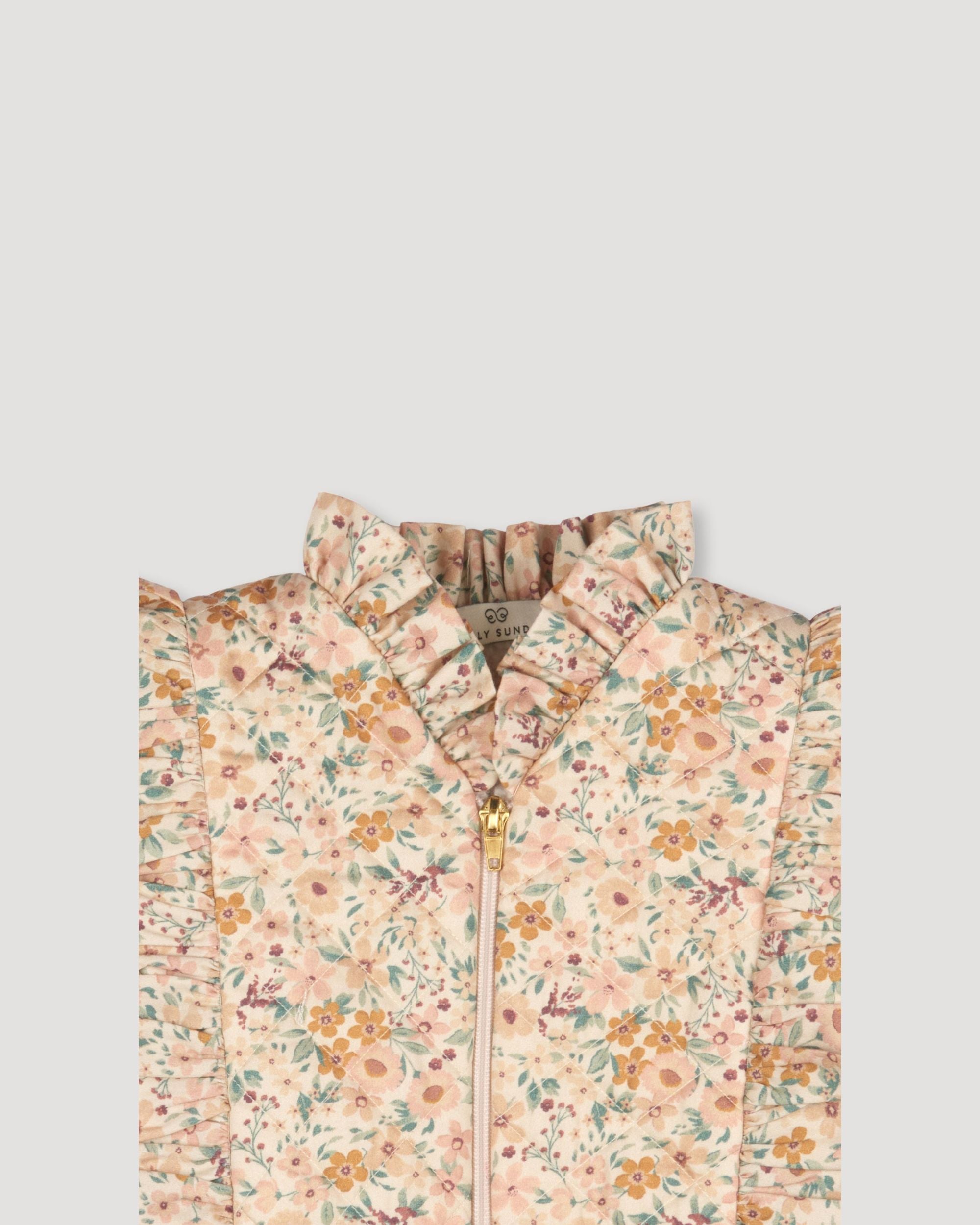 Early Sunday, Deborah Jacket in Floral print, made from Printed 30s Cotton Twill fabric, featuring Sleeveless design ideal for versatile layering in transitional weather, shown in a closeup flat-lay view