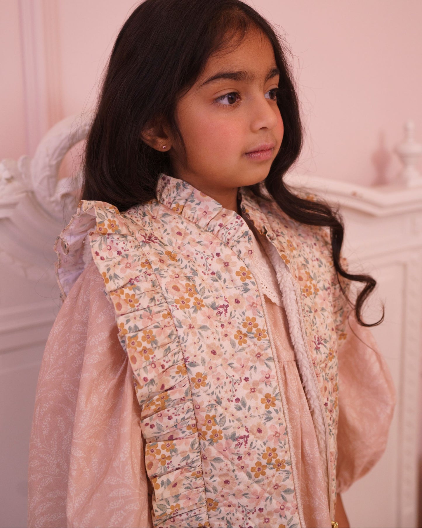 Early Sunday, Deborah Jacket in Floral print, made from Printed 30s Cotton Twill fabric, featuring Sleeveless design ideal for versatile layering in transitional weather, shown in a close up shot of model wearing it