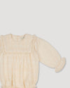 Early Sunday, Dolly Baby Bubble Romper in Hazelnut Cream color, made from All-over Embroidered Cotton Cambric fabric, featuring smocked sleeves & a square lace yoke, shown in a closeup flat-lay view