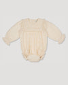 Early Sunday, Dolly Baby Bubble Romper in Hazelnut Cream color, made from All-over Embroidered Cotton Cambric fabric, featuring smocked sleeves & a square lace yoke, shown in a front flat-lay view