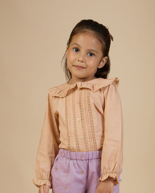 Early Sunday, Ella Blouse in Nude, made from Cotton Cambric fabric, featuring relaxed fit, frill detailing on the collar, and lace inserts, shown in a close-up side view of a model wearing it