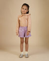 Early Sunday, Ella Blouse in Nude, made from Cotton Cambric fabric, featuring relaxed fit, frill detailing on the collar, and lace inserts, shown in a front view of model wearing it