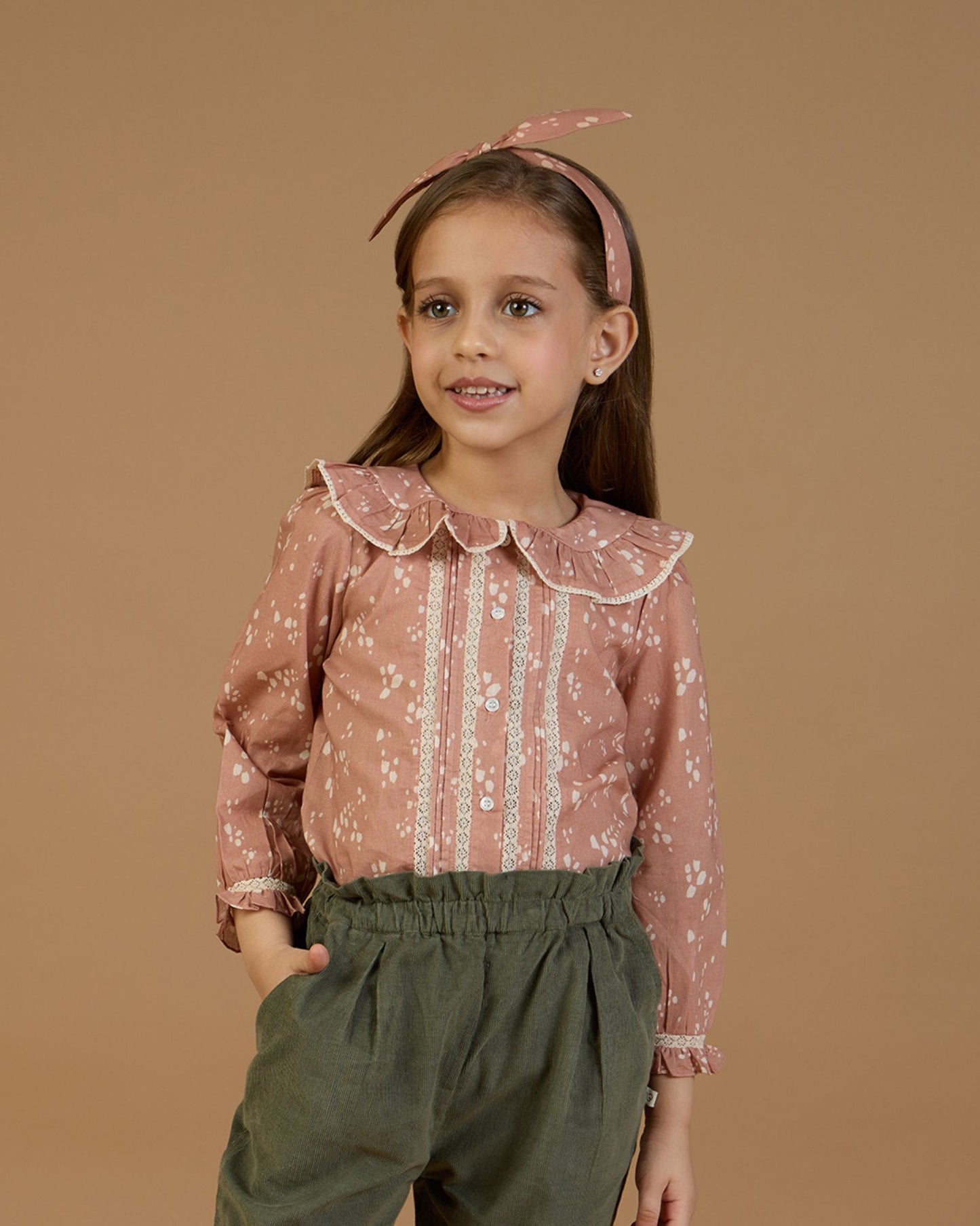 Early Sunday, Ella Blouse in Fawn Soft Pinkish Brown, made from Printed Cotton Cambric fabric, featuring relaxed fit, frill detailing on the collar, and lace inserts, shown in a close-up shot of a model wearing it during a studio shoot