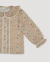 Early Sunday, Ella Blouse in Garden Flowers Cream, made from Printed Cotton Cambric fabric, featuring relaxed fit, frill detailing on the collar, and lace inserts, shown in a closeup flat-lay view
