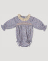 Early Sunday, Ellie Baby Bubble Romper in Celestial print, made from Printed 60s cotton satin fabric, featuring smocked sleeves with laced neckline, shown in a front flat-lay view