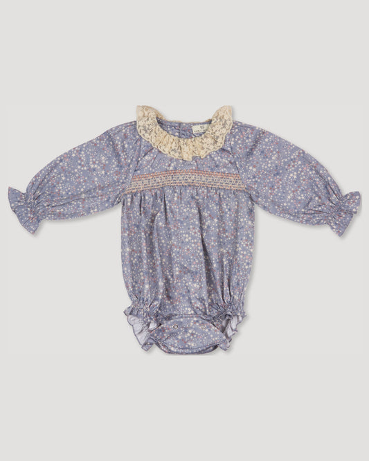 Early Sunday, Ellie Baby Bubble Romper in Celestial print, made from Printed 60s cotton satin fabric, featuring smocked sleeves with laced neckline, shown in a front flat-lay view