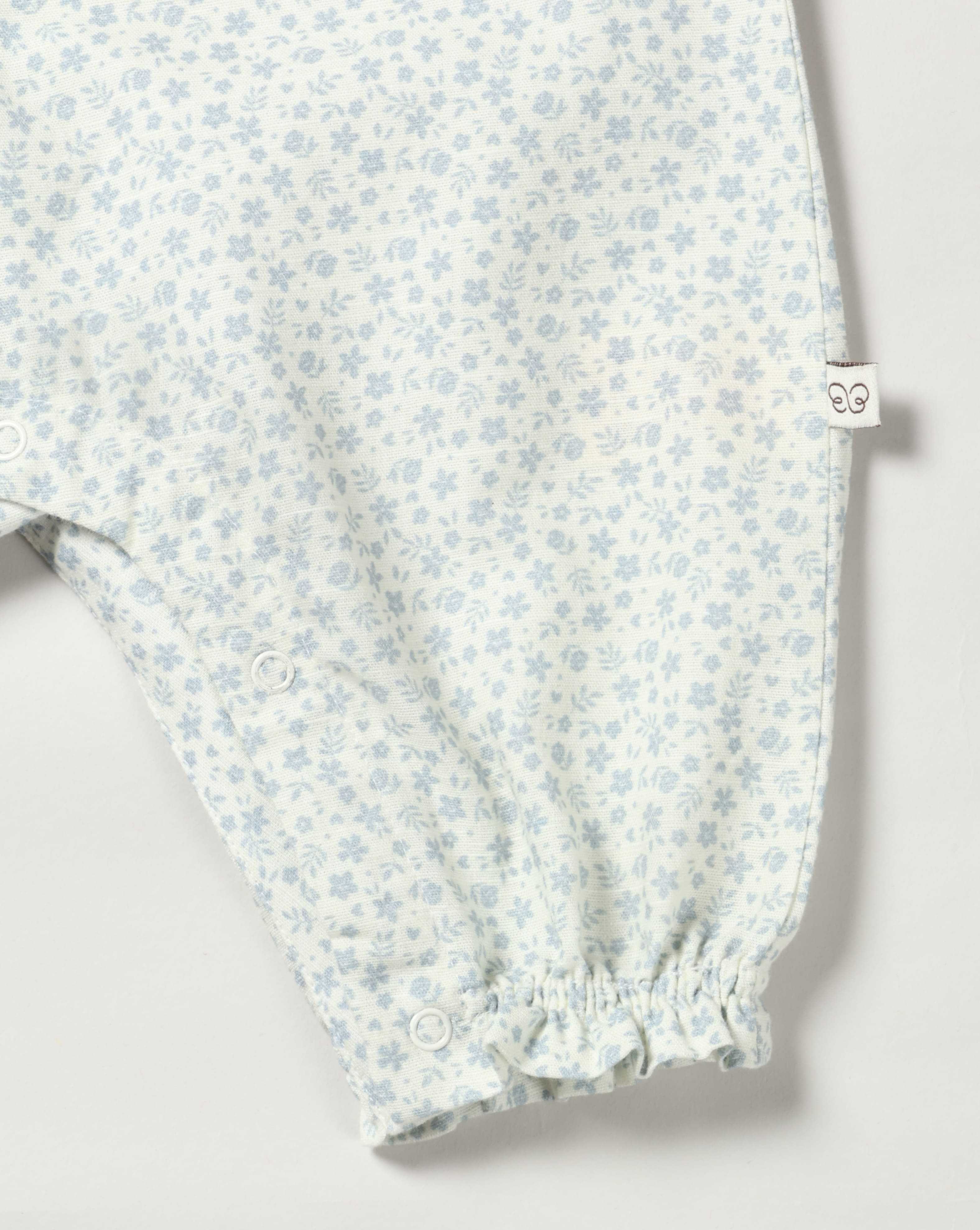 Early Sunday, Emma Baby Smocked Overalls Romper in Mini Flower print, made from Printed canvas 70% Cotton 30% Linen fabric, featuring a relaxed fit with smocked chest band & frilled sleeves, shown in a closeup flat-lay view