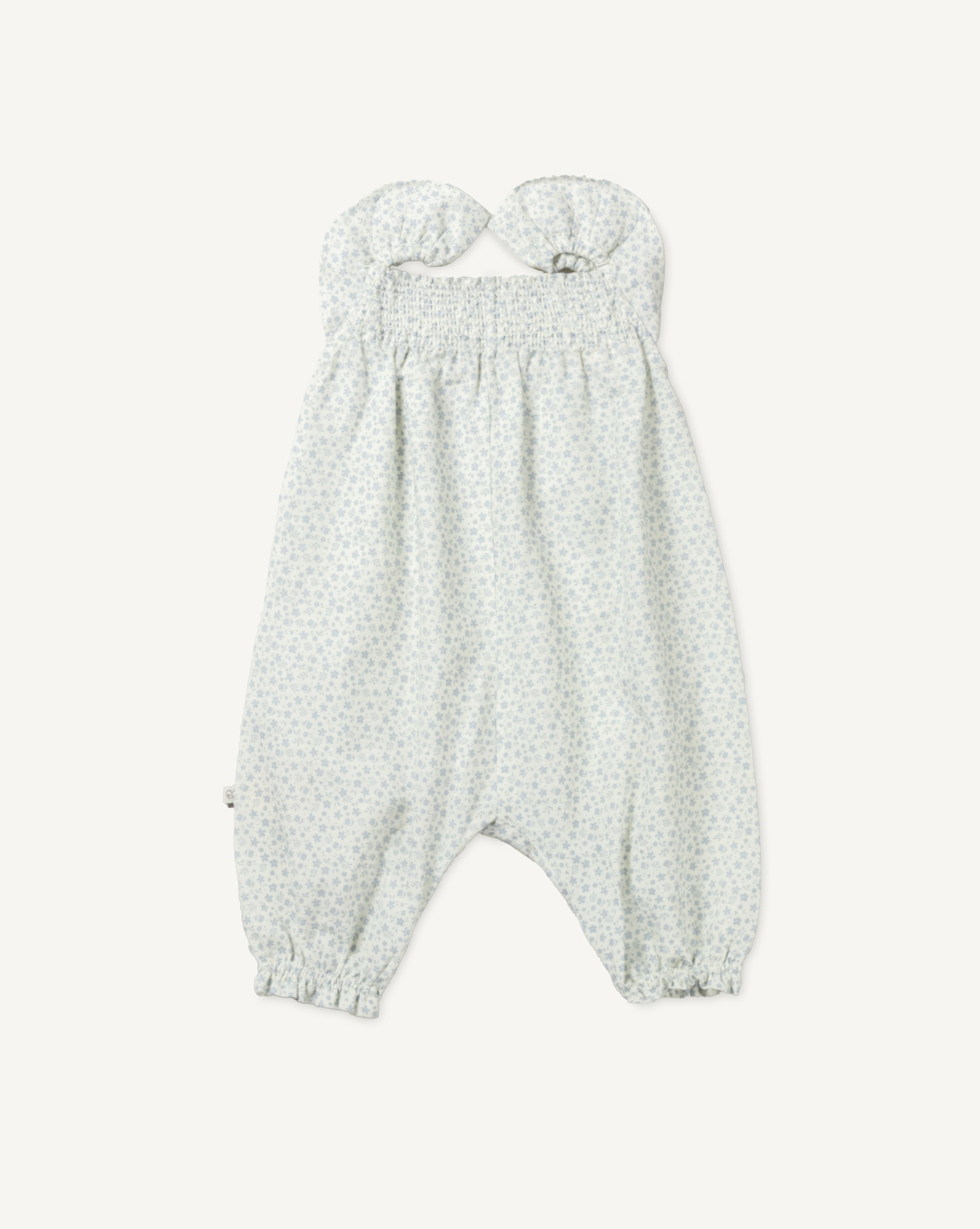 Early Sunday, Emma Baby Smocked Overalls Romper in Mini Flower print, made from Printed canvas 70% Cotton 30% Linen fabric, featuring a relaxed fit with smocked chest band & frilled sleeves, shown in a front flat-lay view