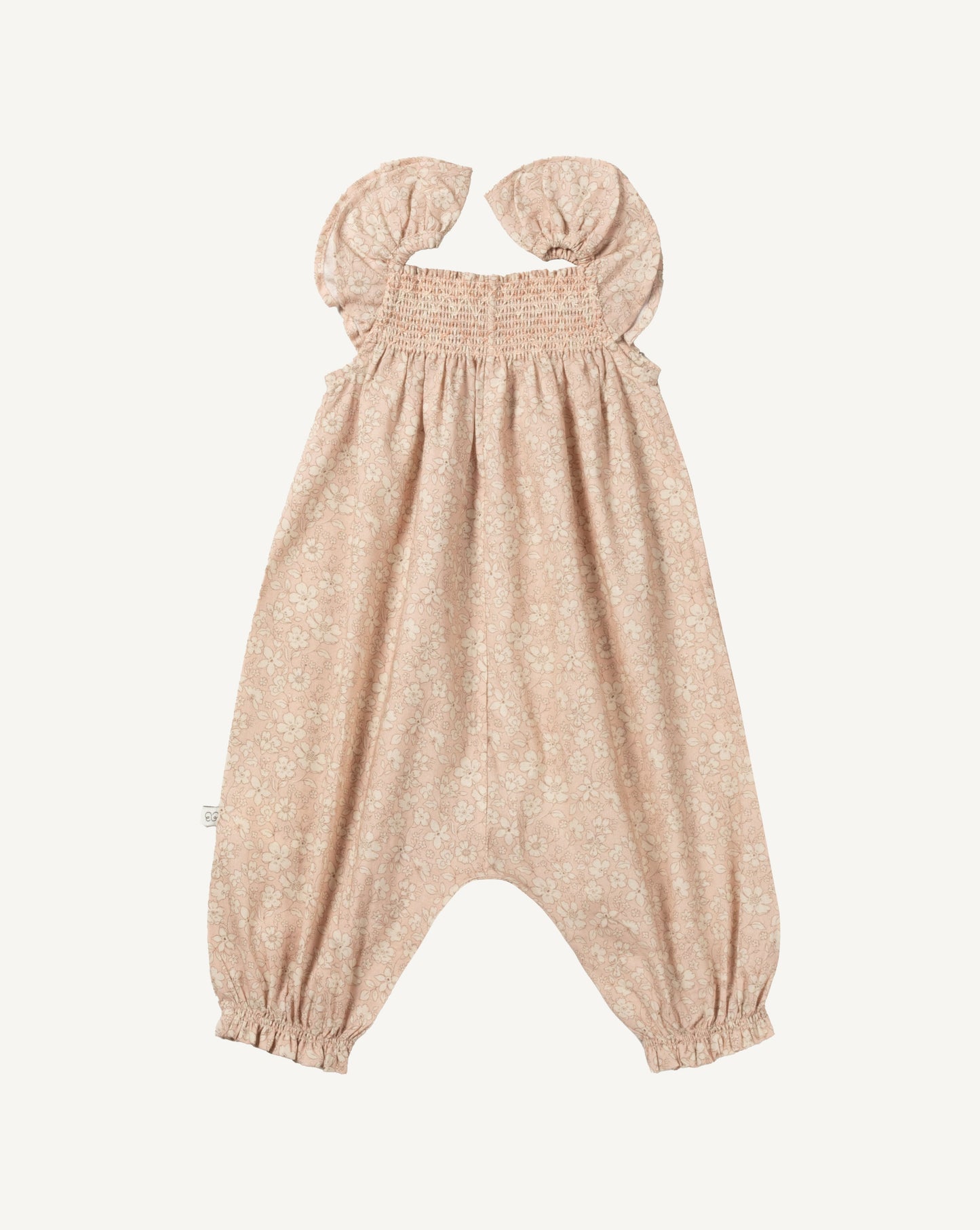 Early Sunday, Emma Baby Smocked Overalls Romper in Garden Flowers print, made from Printed Cotton Cambric fabric, featuring a relaxed fit with smocked chest band & frilled sleeves, shown in a front flat-lay view