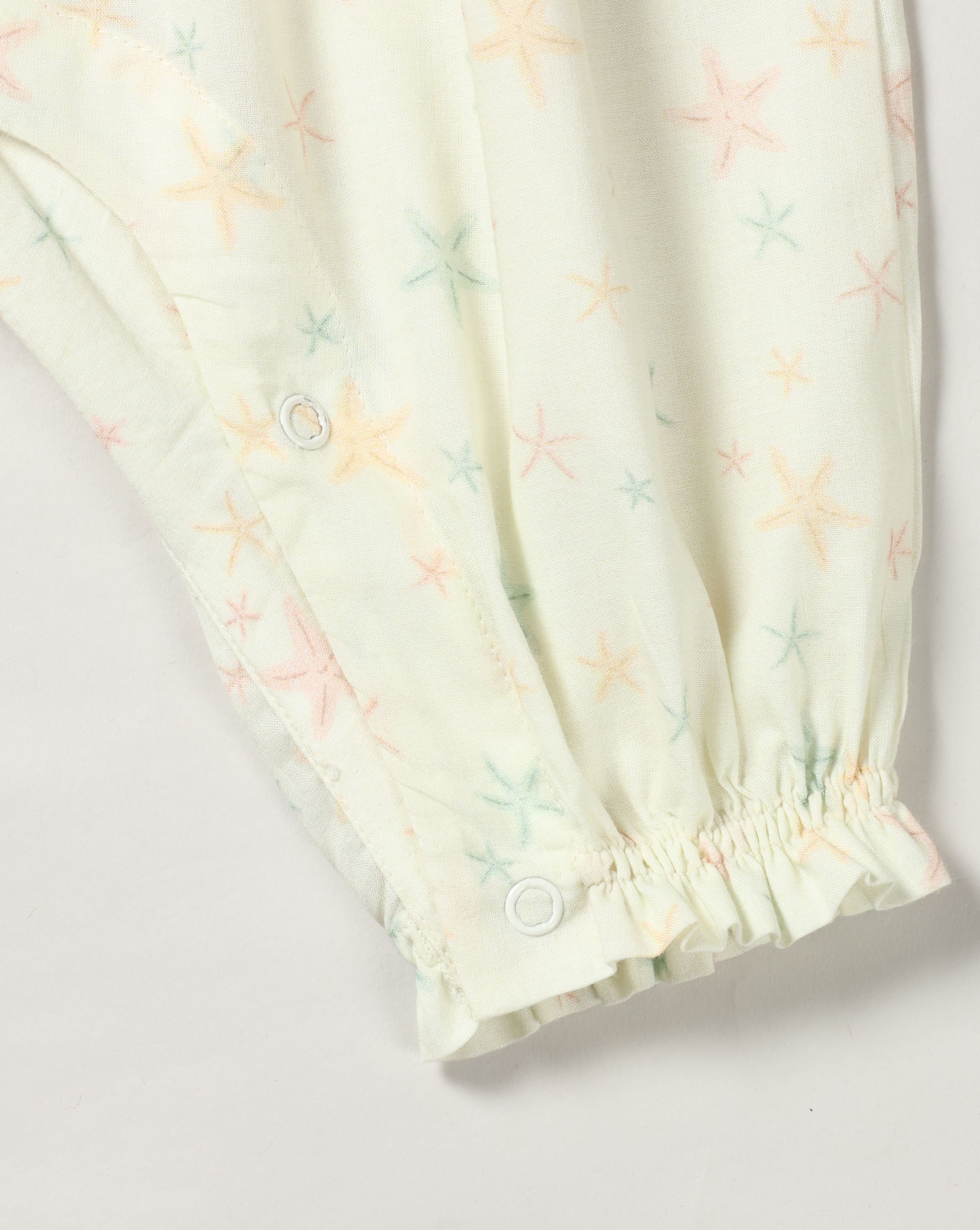 Early Sunday, Emma Baby Smocked Overalls Romper in Star Fish print, made from Printed Cotton Cambric fabric, featuring a relaxed fit with smocked chest band & frilled sleeves, shown in a closeup flat-lay view