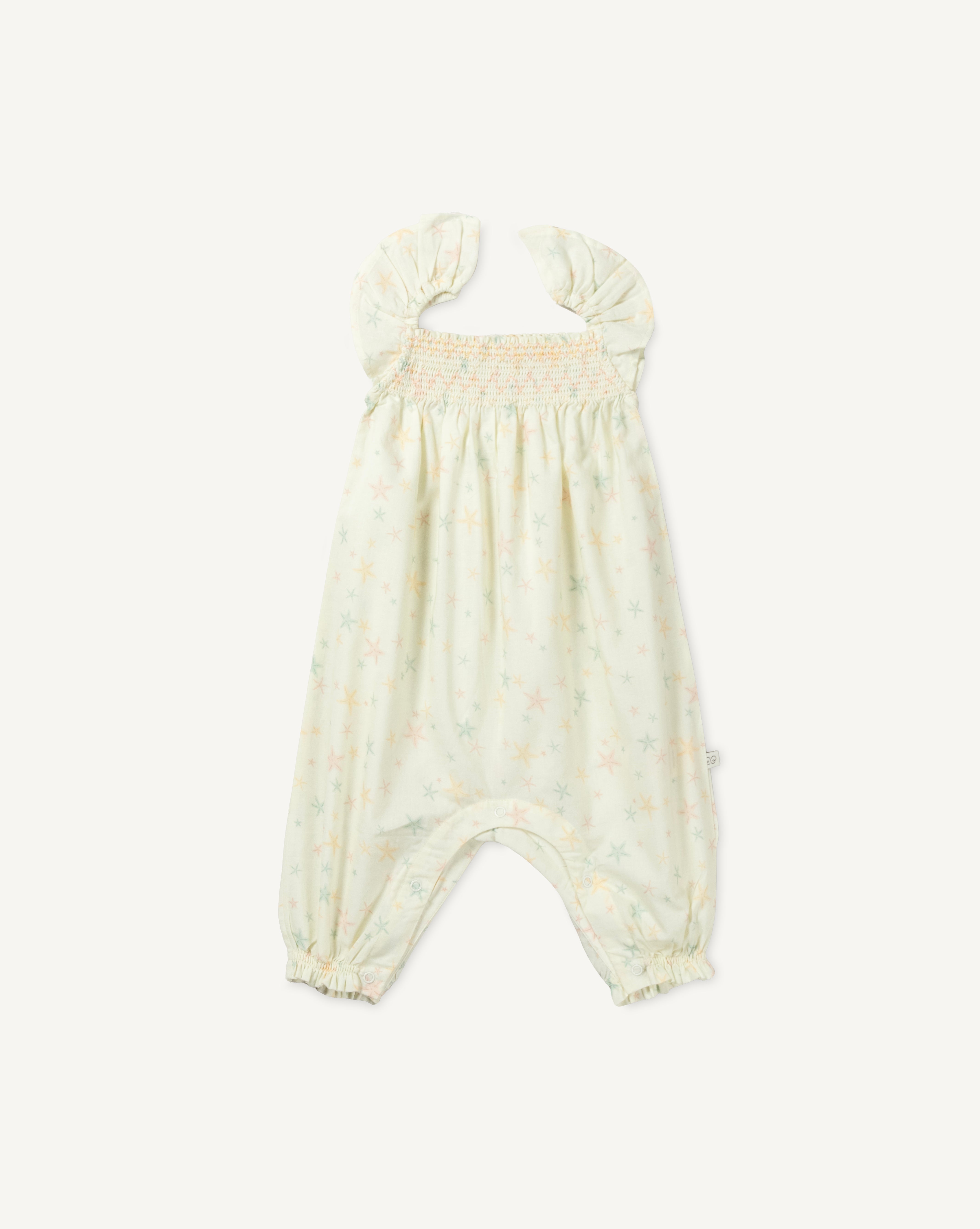 Early Sunday, Emma Baby Smocked Overalls Romper in Star Fish print, made from Printed Cotton Cambric fabric, featuring a relaxed fit with smocked chest band & frilled sleeves, shown in a front flat-lay view