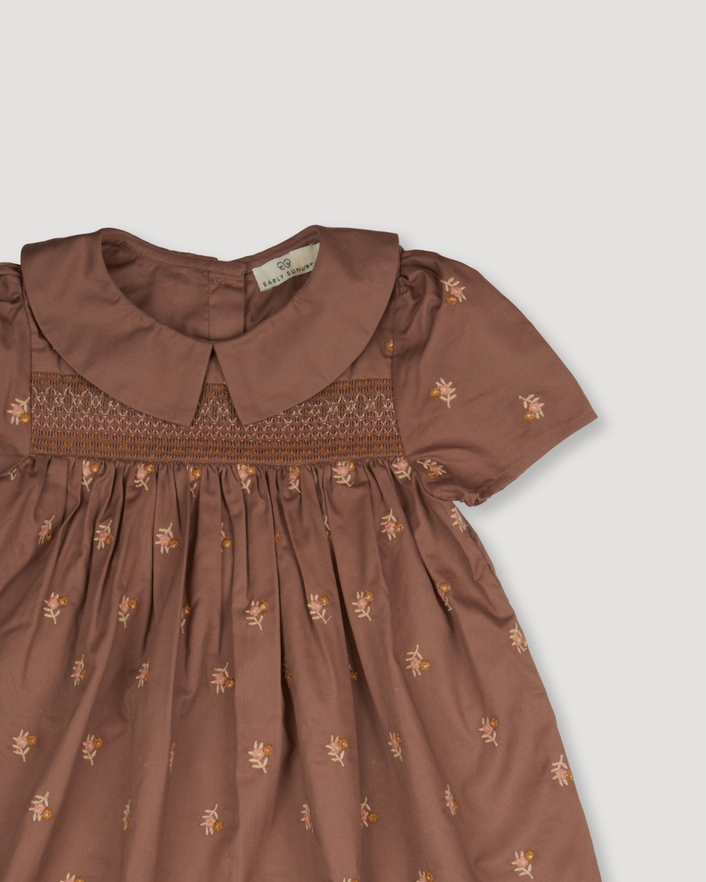 Early Sunday, Erika Dress in Bark, made from All-Over Embroidered 30s Cotton Brushed Twill fabric, featuring Flowy A-line silhouette allows ease of movement and day-long comfort, shown in a closeup flat-lay view