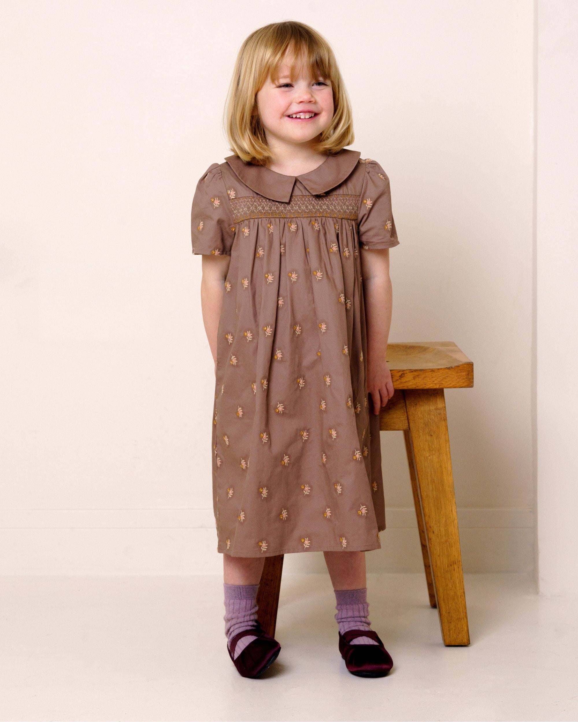 Early Sunday, Erika Dress in Bark, made from All-Over Embroidered 30s Cotton Brushed Twill fabric, featuring Flowy A-line silhouette allows ease of movement and day-long comfort, shown in a front view of model wearing it