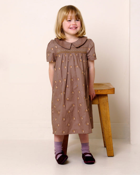 Early Sunday, Erika Dress in Bark, made from All-Over Embroidered 30s Cotton Brushed Twill fabric, featuring Flowy A-line silhouette allows ease of movement and day-long comfort, shown in a front view of model wearing it