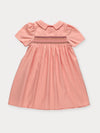 Early Sunday, Erika Dress in Blush Pink, made from Cotton Satin fabric, featuring a floral embroidery on a Peter Pan collar with a delicately smocked chest, shown in a back flat-lay view