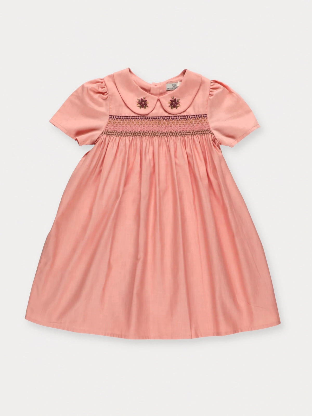 Early Sunday, Erika Dress in Blush Pink, made from Cotton Satin fabric, featuring a floral embroidery on a Peter Pan collar with a delicately smocked chest, shown in a front flat-lay view