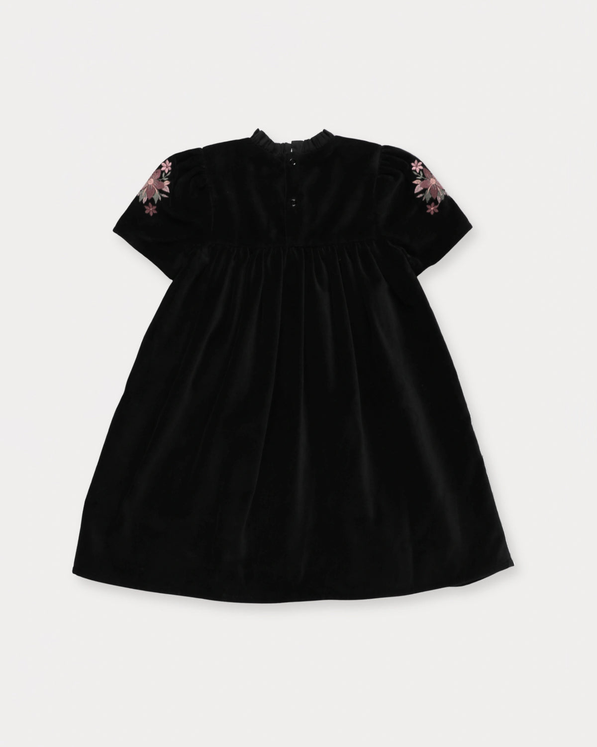 Early Sunday, Erika Dress in Black, made from Cotton Velvet Velour's fabric, featuring a beautiful embroidery with frilled neckline, shown in a back flat-lay view