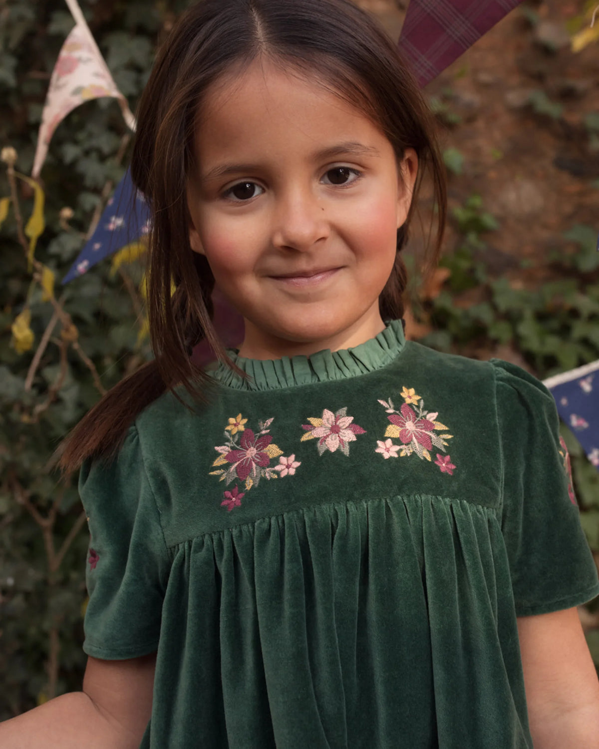 Early Sunday, Erika Dress in Forest Green, made from Cotton Velvet Velour's fabric, featuring a beautiful embroidery with frilled neckline, shown in a close up shot of model wearing it