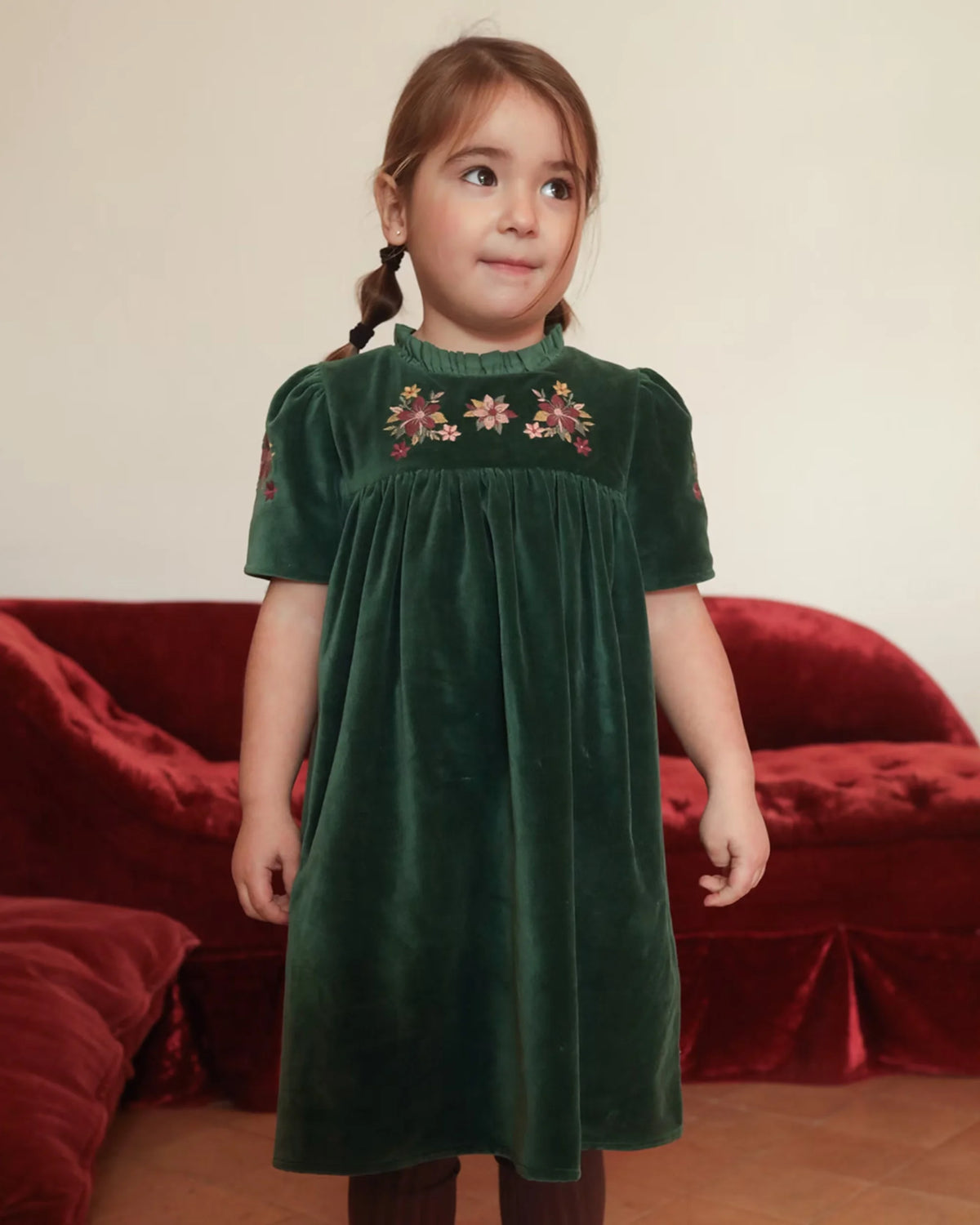 Early Sunday, Erika Dress in Forest Green, made from Cotton Velvet Velour's fabric, featuring a beautiful embroidery with frilled neckline, shown in a front view of model wearing it