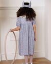 Early Sunday, Erika Dress in Celestial print, made from Printed Cotton Satin fabric, featuring Flowy A-line silhouette allows ease of movement and day-long comfort, shown in a back view of model wearing it